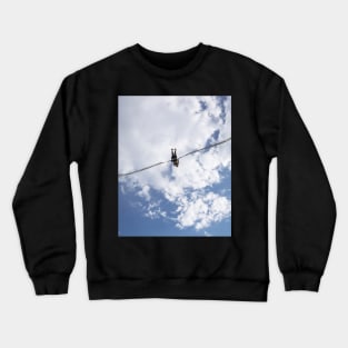 Girl in slingshot against blue cloudy sky Crewneck Sweatshirt